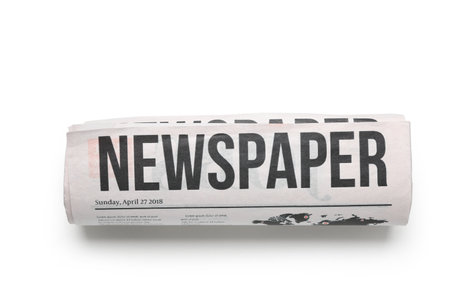 Rolled newspaper isolated on white backgroundの写真素材