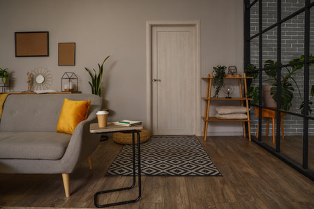 Interior of modern living room with door, tables and sofaの写真素材