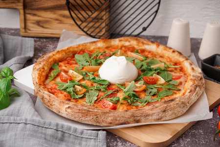 Tasty pizza with Burrata cheese on tableの写真素材