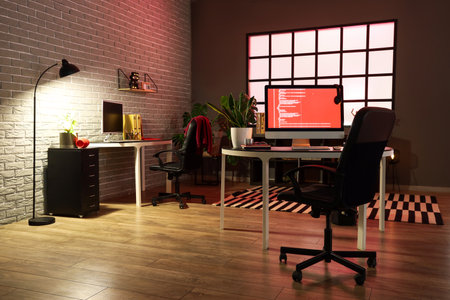Interior of dark office with programmer's workplacesの写真素材
