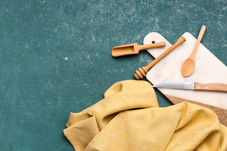 Kitchen utensils and clean napkin on color backgroundの写真素材