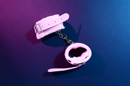 Handcuffs from sex shop on dark color backgroundの写真素材