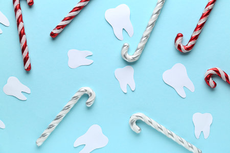 Paper teeth with candy canes on blue backgroundの写真素材