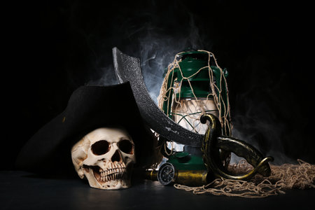 Travel equipment with oil lamp, human skull and net on black backgroundの写真素材