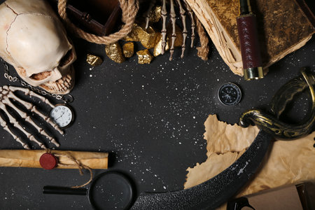 Travel equipment with golden nuggets, human skull and net on black backgroundの写真素材