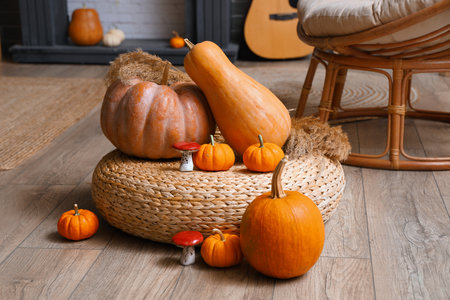 Rattan pouf with pumpkins and mushrooms in living roomの写真素材
