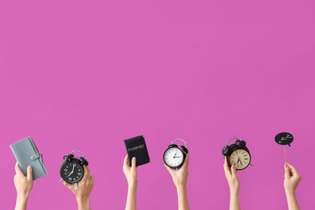Hands holding alarm clock, wallet, passport and speech bubble on purple background