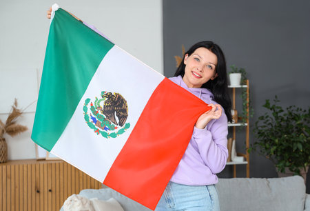Young woman with Mexican flag at homeの写真素材