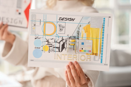 Female interior designer with plan in office, closeupの写真素材