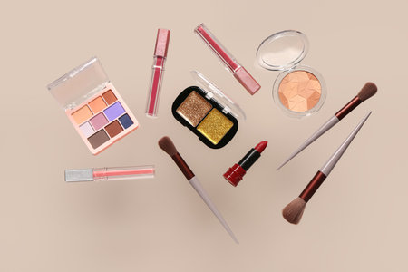 Flying decorative cosmetics on beige backgroundの写真素材