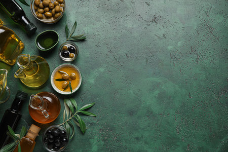 Bowls and glassware of fresh olive oil on green backgroundの写真素材