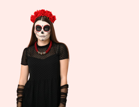 Young woman dressed for Halloween on light backgroundの写真素材