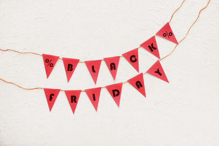 Rope, flags with text BLACK FRIDAY and percent signs on white background