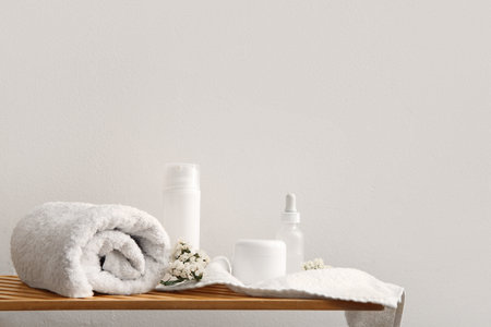 Set of spa supplies on table near white wallの写真素材