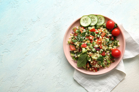 Plate with delicious tabbouleh salad on light backgroundの写真素材