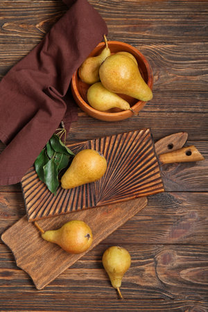 Bowl with ripe pears on wooden backgroundの写真素材
