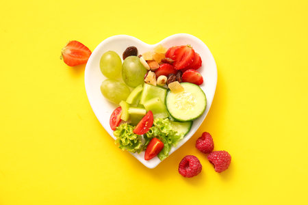 Plate with fresh healthy products on yellow background. Diet conceptの写真素材