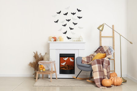 Interior of living room decorated for Halloween with fireplace, rocking chair and paper batsの写真素材