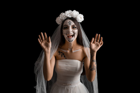 Beautiful young woman dressed as dead bride for Halloween party on black background