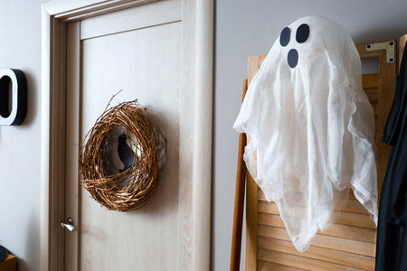 Door with Halloween decorations in festive hallway
