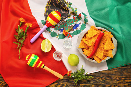 Mexican flag with tequila shots and food for Independence Day on wooden backgroundの写真素材