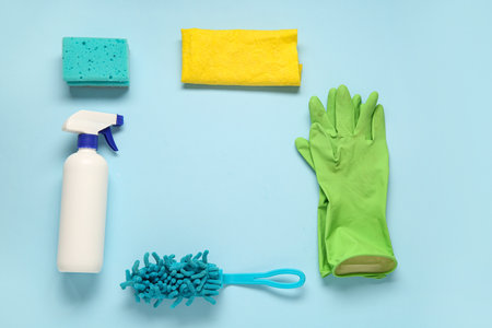 Frame made of house cleaning supplies on blue backgroundの写真素材