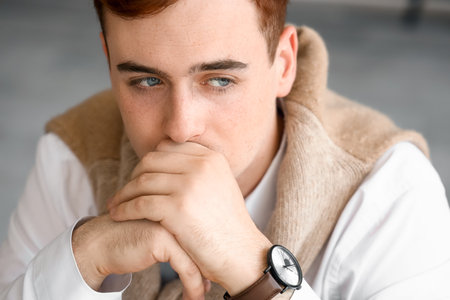 Fearful young businessman in office, closeupの写真素材