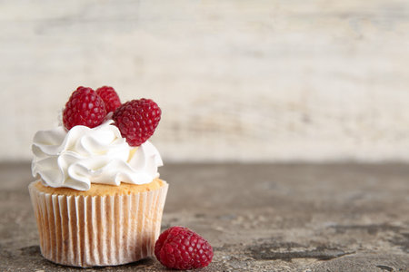 Tasty raspberry cupcake on tableの写真素材
