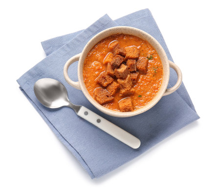 Pot of tasty cream soup with croutons on white backgroundの写真素材