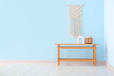 Wooden coffee table with decor near blue wallの写真素材
