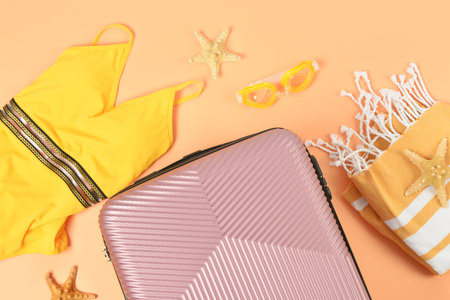 Composition with suitcase and beach accessories on color background, closeupの写真素材