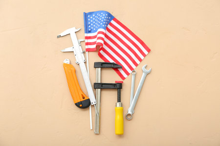 Different tools and USA flag on beige background. Labor Day celebrationの写真素材