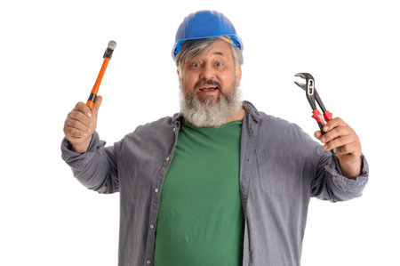 Portrait of senior man in hardhat with hammer and pincers isolated on white background. Labor Day celebrationの写真素材