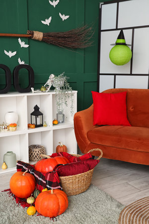 Interior of living room decorated for Halloween with red sofa and shelf unitの写真素材