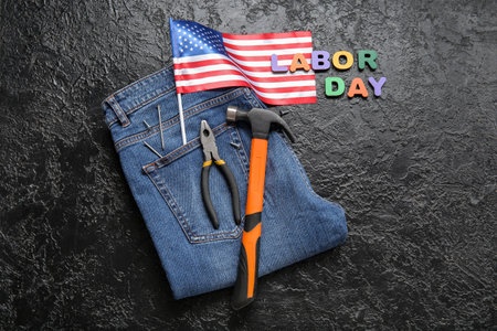 Jeans with tools, USA flag and text LABOR DAY on black grunge backgroundの写真素材