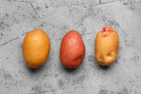 Fresh raw potatoes on blue backgroundの写真素材
