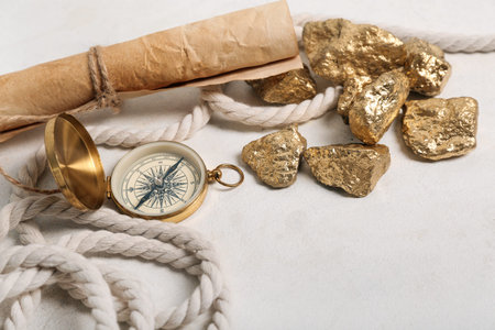 Travel equipment with scroll and golden nuggets on white background