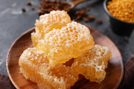 Plate with sweet honeycombs on black backgroundの写真素材