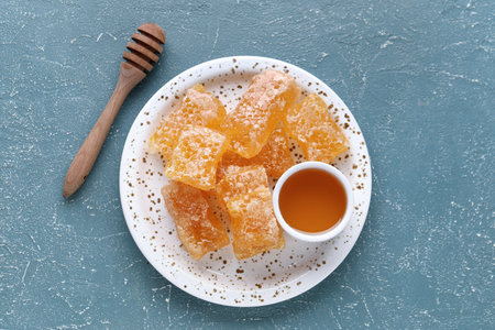 Plate with sweet honeycombs on blue backgroundの写真素材