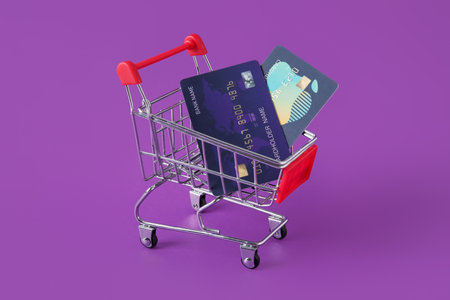 Shopping card and credit cards on purple backgroundの写真素材