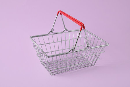 Shopping basket on purple background, closeupの写真素材