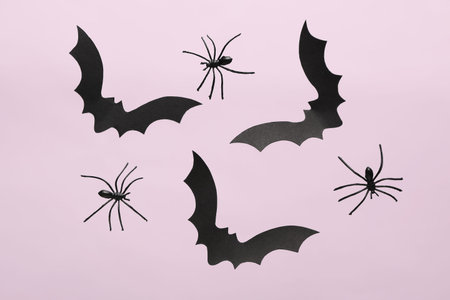 Paper bats and spiders for Halloween party on lilac backgroundの写真素材