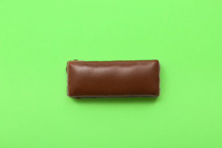 Tasty chocolate covered coconut candy on green backgroundの写真素材