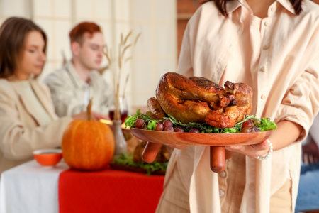 Young woman with turkey having dinner on Thanksgiving Day, closeupの写真素材