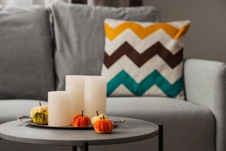 Halloween pumpkins with candles on table in living room, closeupの写真素材