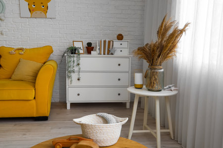 Interior of children's room with drawers and tableの写真素材
