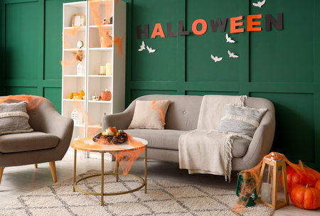 Interior of living room decorated for Halloween with gray sofa and armchairの写真素材