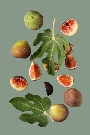 Fresh ripe figs and leaves on green backgroundの写真素材