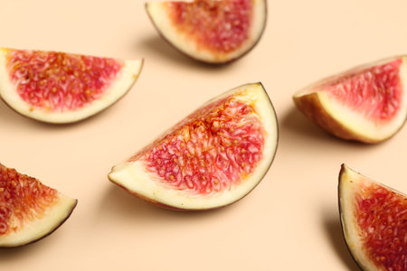 Pieces of fresh ripe figs on orange background