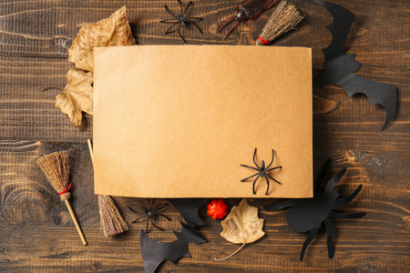 Blank greeting card with Halloween decorations on brown wooden backgroundの写真素材